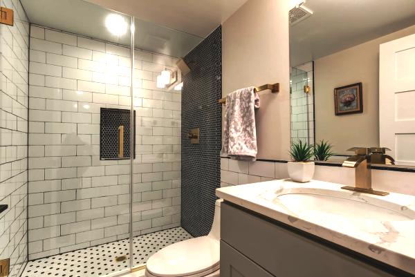 Bathroom remodel with black and white tile.